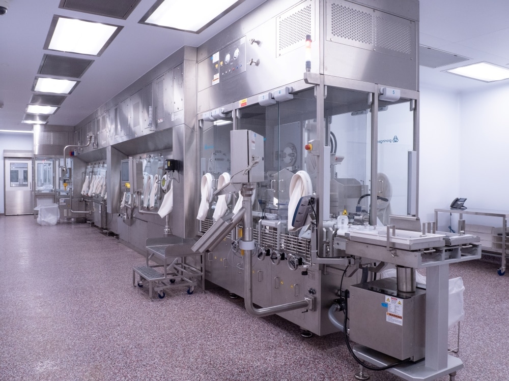 Groninger FlexPro 50 aseptic filling line with isolator glove ports in Bora sterile manufacturing facility.